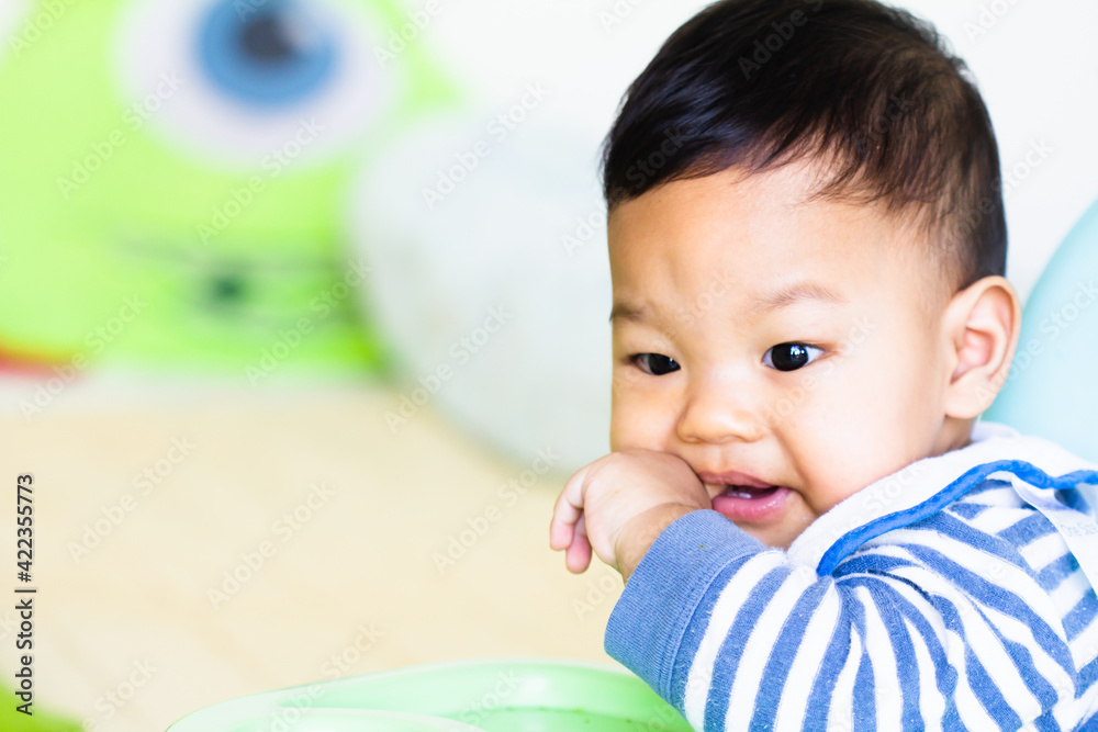 Portrait of a newborn Asian baby sucking their fingers Portrait of a newborn Asian baby sucking their fingers