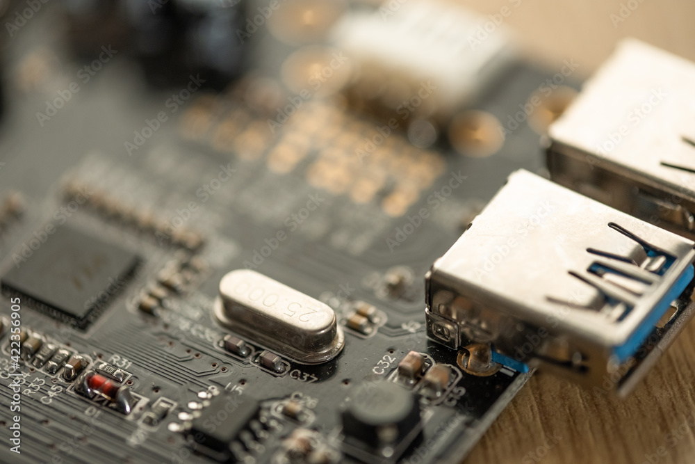 Shallow focus of surface mount components seen on a USB3 hardware PCB. One of the USB3 connectors can be seen on the right. Shallow focus of surface mount components seen on a USB3 hardware PCB. One of the USB3 connectors can be seen on the right.