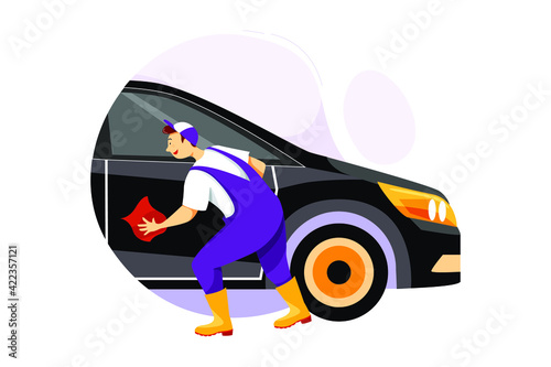 Worker wiping the windows dry after washing the car