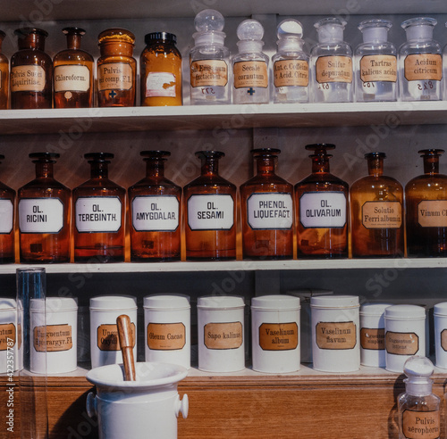 Historic jars and mortar with medicines in a historic pharmacy. Latin names. Apotheek. Historic drugstore.  photo