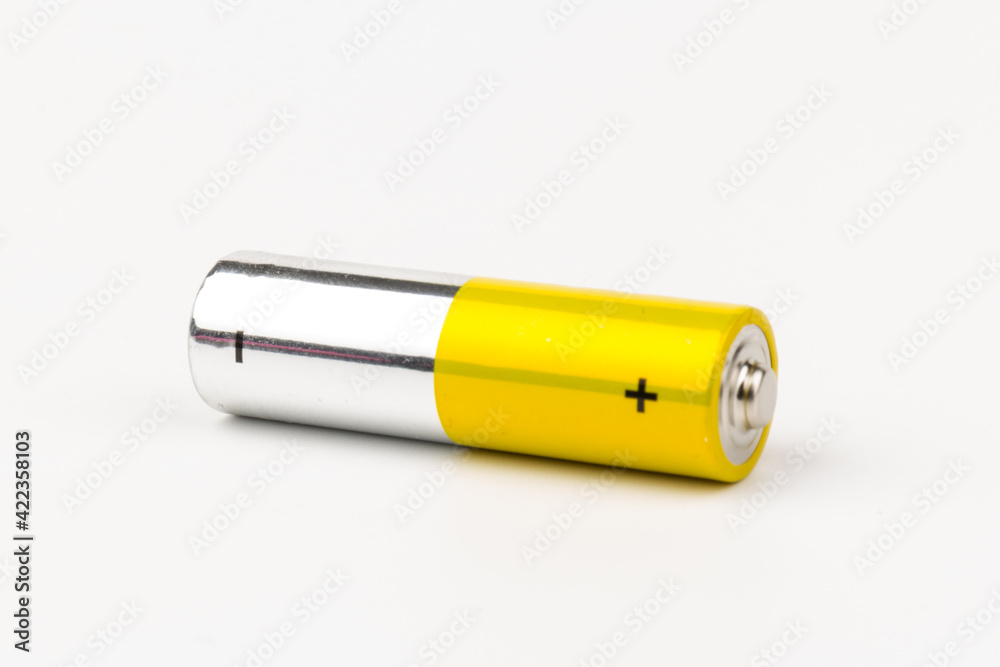 Photo of gray-yellow alkaline AA batteries on white background. Recycling of rechargeable NiMH batteries. The most popular size of accumulators. Copy space. Photo of gray-yellow alkaline AA batteries on white background. Recycling of rechargeable NiMH batteries. The most popular size of accumulators. Copy space.