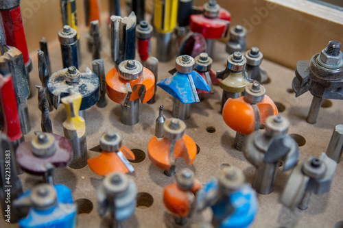 assorted router bits for shaping wood edges in carpentry and furniture making. photo