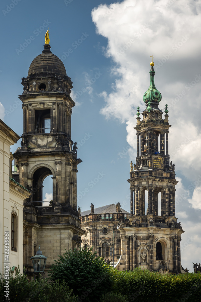 Fototapeta premium two towers of old buildings against the blue sky with clouds 