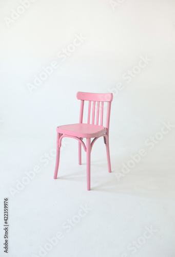 Pink old wooden chair isolated on a white background. Space for text. Vacant chair. The concept of selection and casting. 