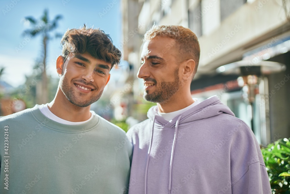 Young gay couple smiling happy and hugging at the city. Young gay couple smiling happy and hugging at the city.