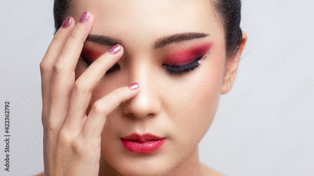 Asian female closeup colorful eyeshadow with extreme long false eyelashes. Eyelash Extensions. Makeup, Cosmetics, Beautiful cosmetics makeup concept. Asian female closeup colorful eyeshadow with extreme long false eyelashes. Eyelash Extensions. Makeup, Cosmetics, Beautiful cosmetics makeup concept.