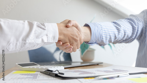 Business people shake hands, Young businessmen shake hands with young women after conversation, Hand-held congratulations, Negotiating business concept.