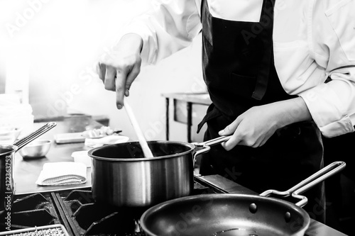 Chef cooking in a kitchen, chef at work, Black and White.