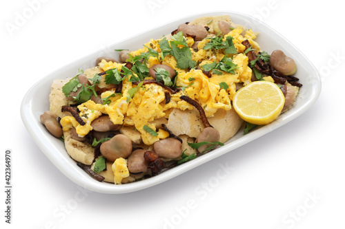 iraqi breakfast; boiled dried broad beans and scrambled eggs over pieces of flatbread ( bagila bil dihin )