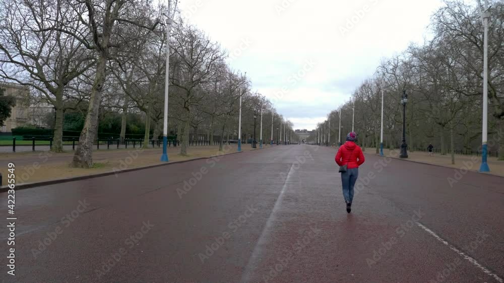 Stabilized shot following a single person walking on the famous The Mall in London with no one else around Stabilized shot following a single person walking on the famous The Mall in London with no one else around