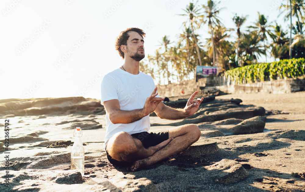 Thoughtful man meditating on beach