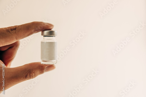 The vaccine vial is held on hand