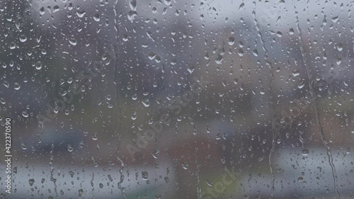 Glass window in rainy weather with raindrops