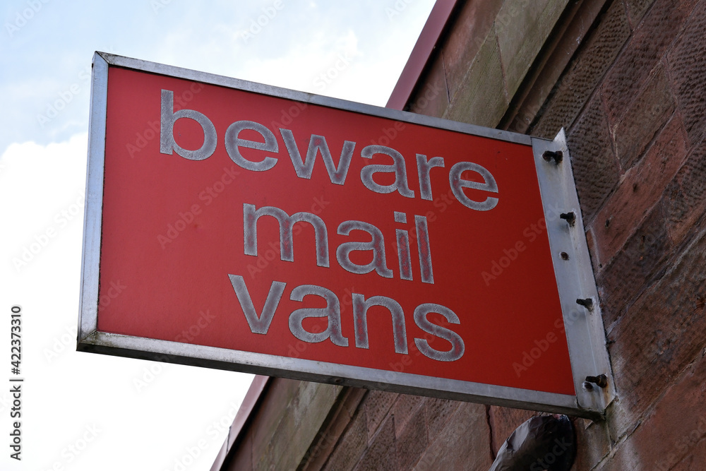 Obraz premium Red Public Warning Sign on Exterior Wall of Industrial Building