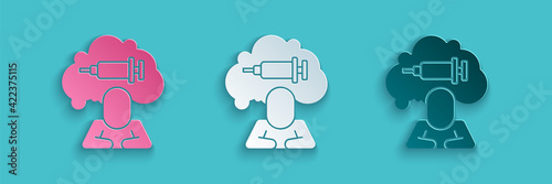 Paper cut Addiction to the drug icon isolated on blue background. Heroin, narcotic, addiction, illegal. Sick junkie with a syringe and medical pills. Paper art style. Vector