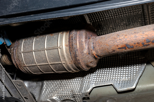 Obraz na płótnie A diesel particulate filter in the exhaust system in a car on a lift in a car workshop, seen from below