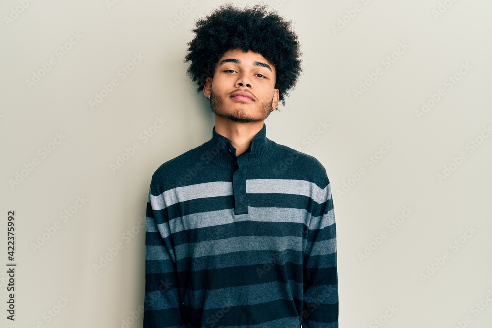 © Krakenimages.com - Young african american man with afro hair wearing casual clothes relaxed with serious expression on face. simple and natural looking at the camera.