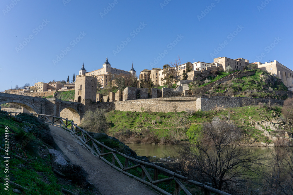 the historic Spanish city of Toledo on the Tagus River with the Roman Bridge in the foreground