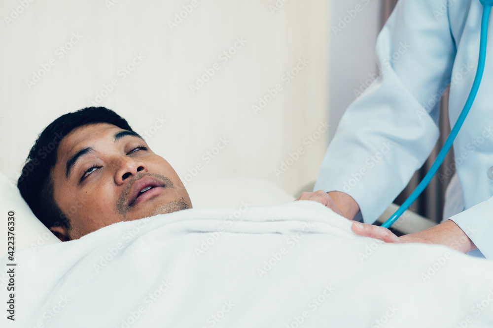 Fototapeta premium Sick Asian man sleeping in bed at hospital ward. concept for medical and healthcare