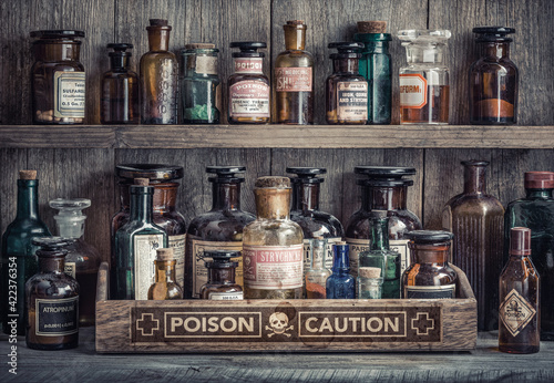 Bottles with drugs from old medical, chemical and pharmaceutical glass. Chemistry and pharmacy history concept background. Retro style. Chemical substances.