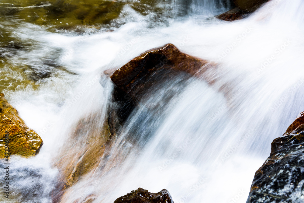 Fototapeta premium The stones under the waterfall, close-up waterfall as background.