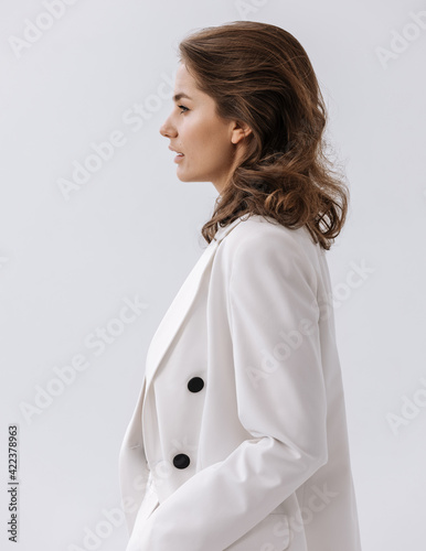 Beauty Fashion brunette model girl wearing stylish suit. Photoshoot in studio