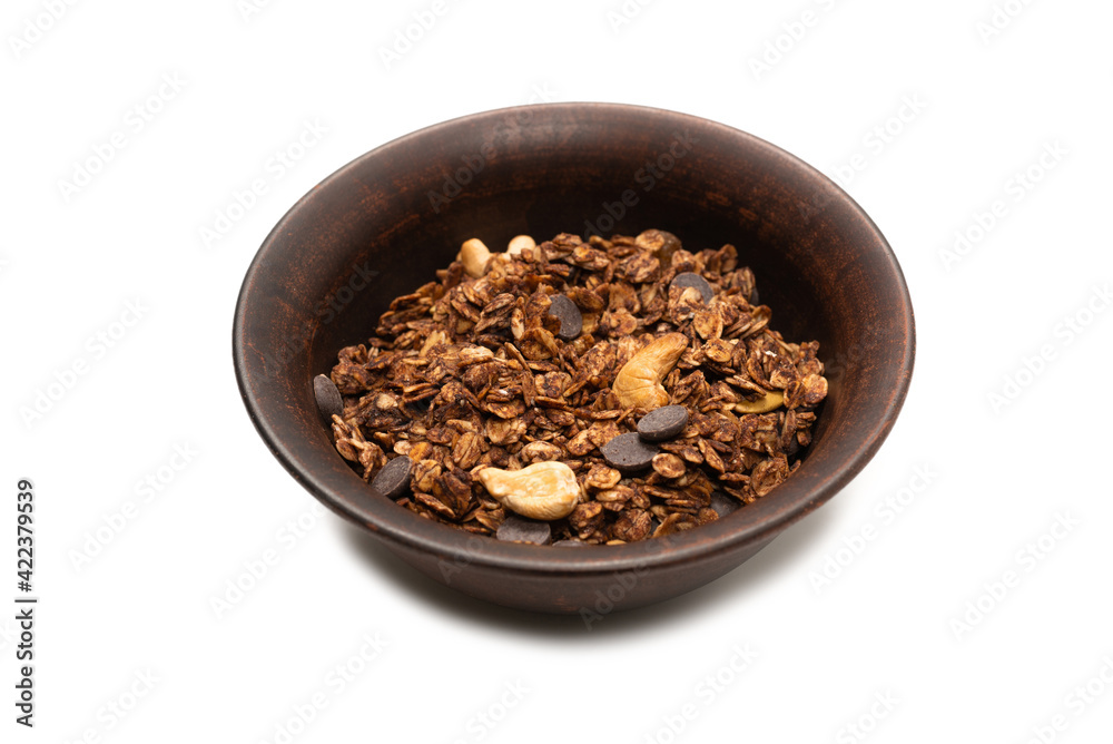 Chocolate granola cereal with nuts in a bowl background. Chocolate granola cereal with nuts in a bowl background.
