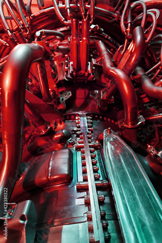 Aircraft turbine in industrial design, engine for generating clean energy in a futuristic red-green light. © Alexander