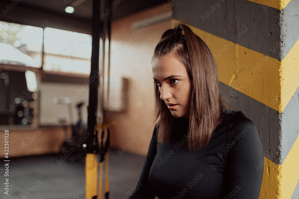 Young sporty woman in sportswear tired and have a break in the gym. Young sporty woman in sportswear tired and have a break in the gym.
