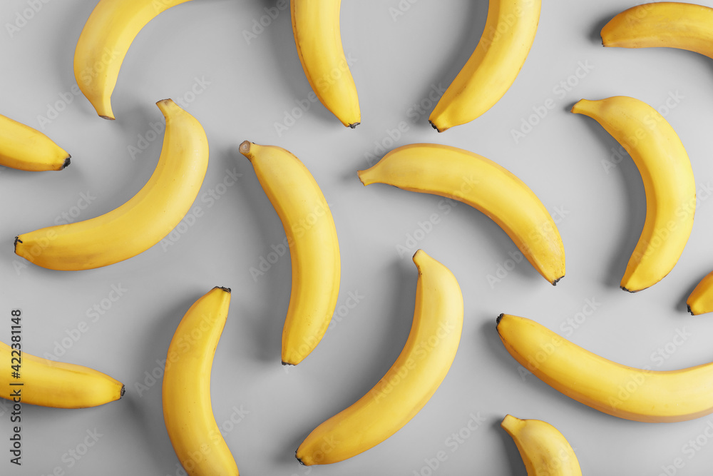 Bright pattern of yellow bananas on a gray background fashionable colors of 2021 Bright pattern of yellow bananas on a gray background fashionable colors of 2021
