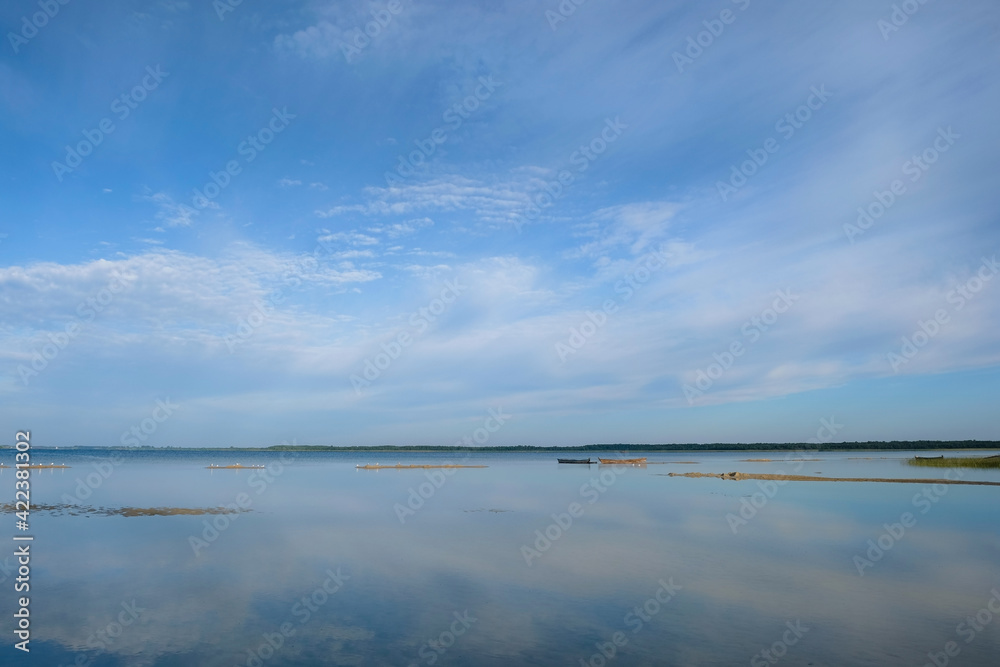 Morning on the lake Svityaz. Clouds are reflected in the water. Shatsky National Natural Park. Ecological landscape. Ukraine. Copy space. 
