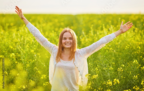 Redhead girl in a rapeseed field