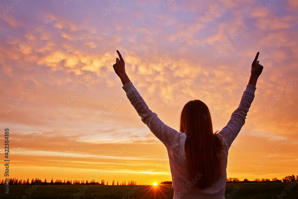 woman feeling victorious facing the beautiful sunset. woman feeling victorious facing the beautiful sunset.