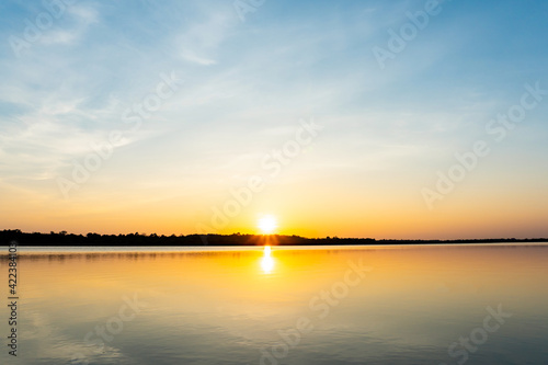 Sunset in the lake, beautiful sunset above the sea landscape background