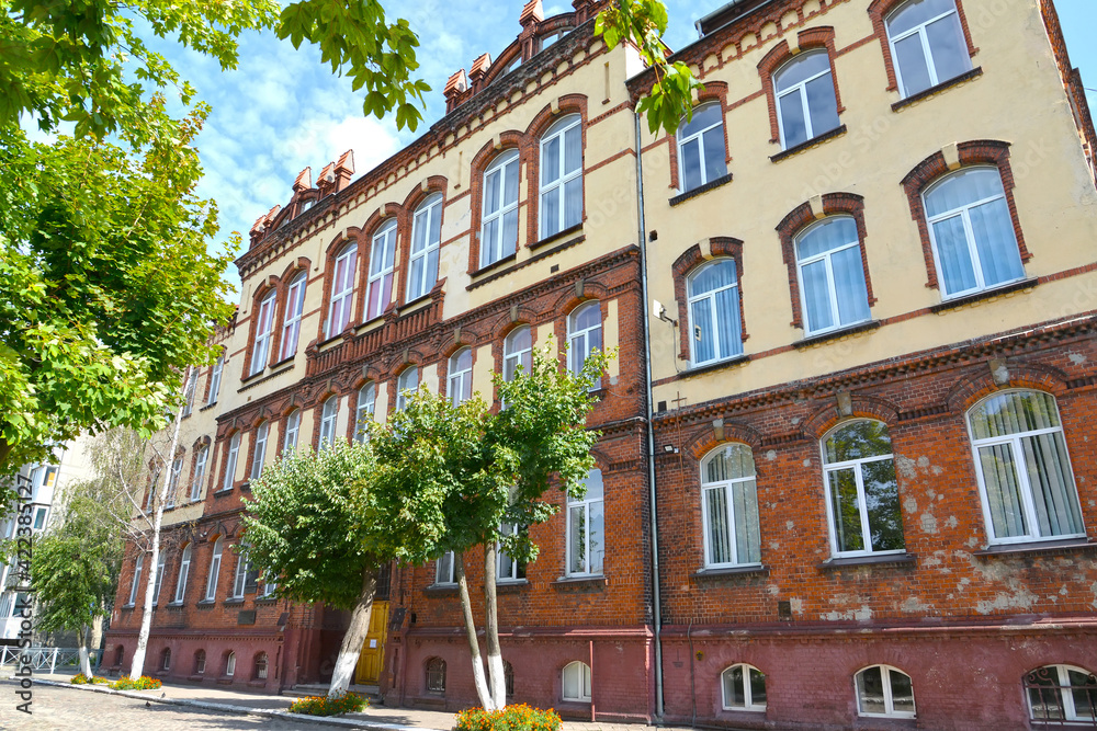 Naklejka premium View of the building of secondary school No. 6 (former secondary school for boys, 1902). Chernyakhovsk, Kaliningrad region