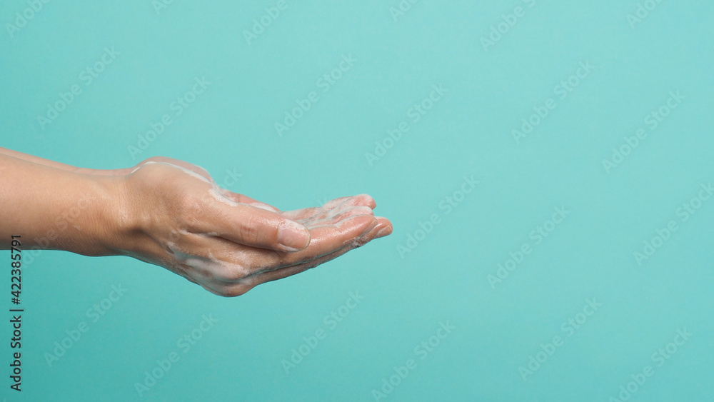 Hands washing gesture with foaming hand soap on green and Tiffany Blue background. Hands washing gesture with foaming hand soap on green and Tiffany Blue background.