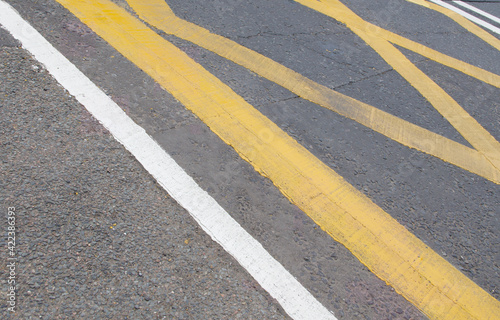 Background with English road markings in yellow and white with copyspace