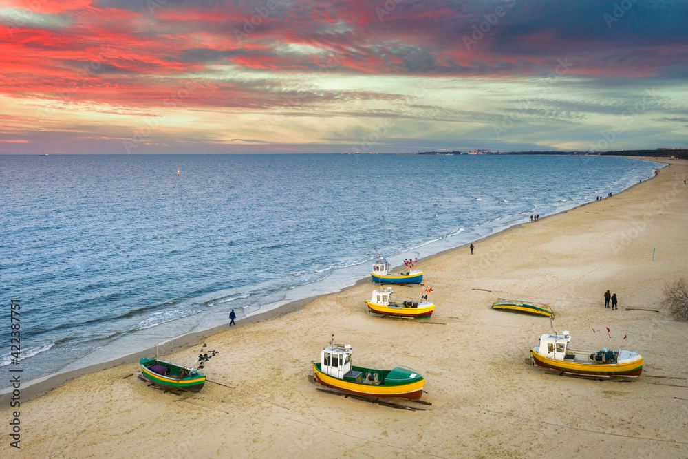 Fototapeta premium Amazing sunset with fishing boats at the beach of Baltic Sea in Sopot, Poland