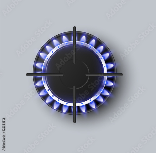 Top view on gas burner ring of kitchen stove with blue burning flame