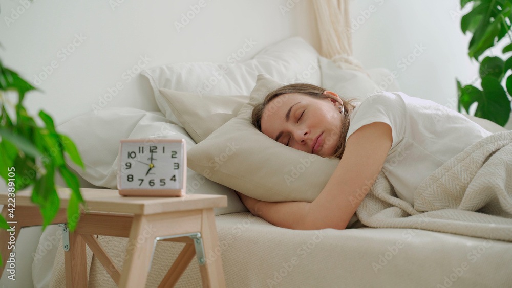 Young woman sleeping on white pillow in bed. Woman peacefully sleeping in bed Young woman sleeping on white pillow in bed. Woman peacefully sleeping in bed