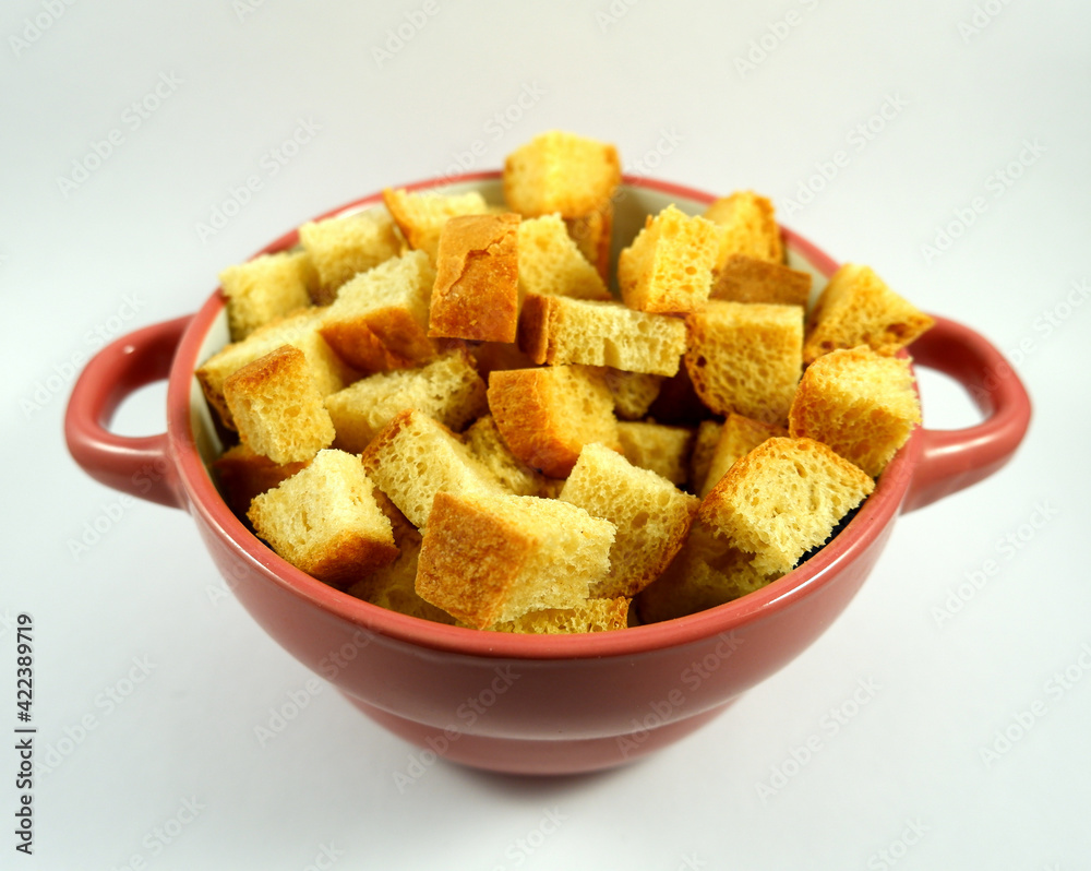 bowl with small croutons on a white plate close up bowl with small croutons on a white plate close up
