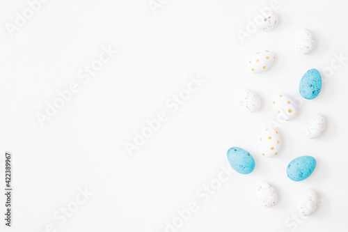 Flat lay easter composition with easter eggs on a light background