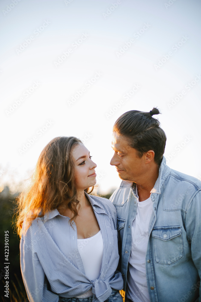happy young couple in the park at sunset. romantic date outside. man and woman look at each other. couple in love outdoors.
happy young couple in the park at sunset. romantic date outside. man and woman look at each other. couple in love outdoors.