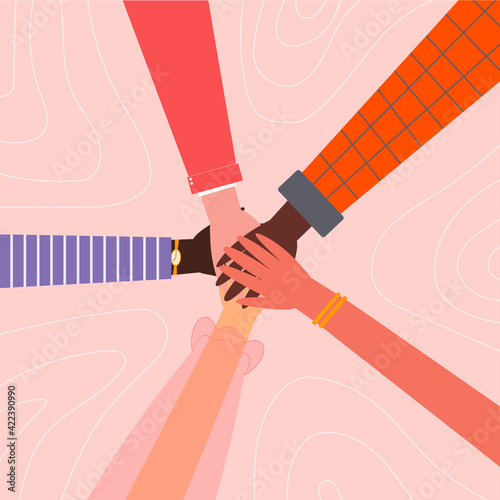Hands in circle. Different colored skinned hands. One for all. Concept of support and solidarity. Diverse women hands on isolated pink background. 