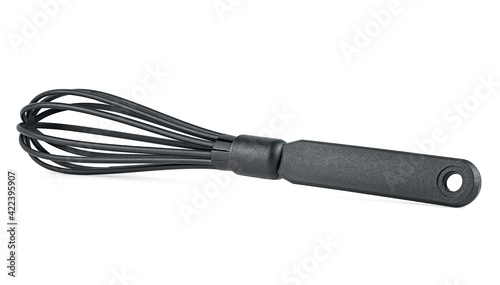 Black manual hand egg beater isolated on a white background. Black kitchen whisk.