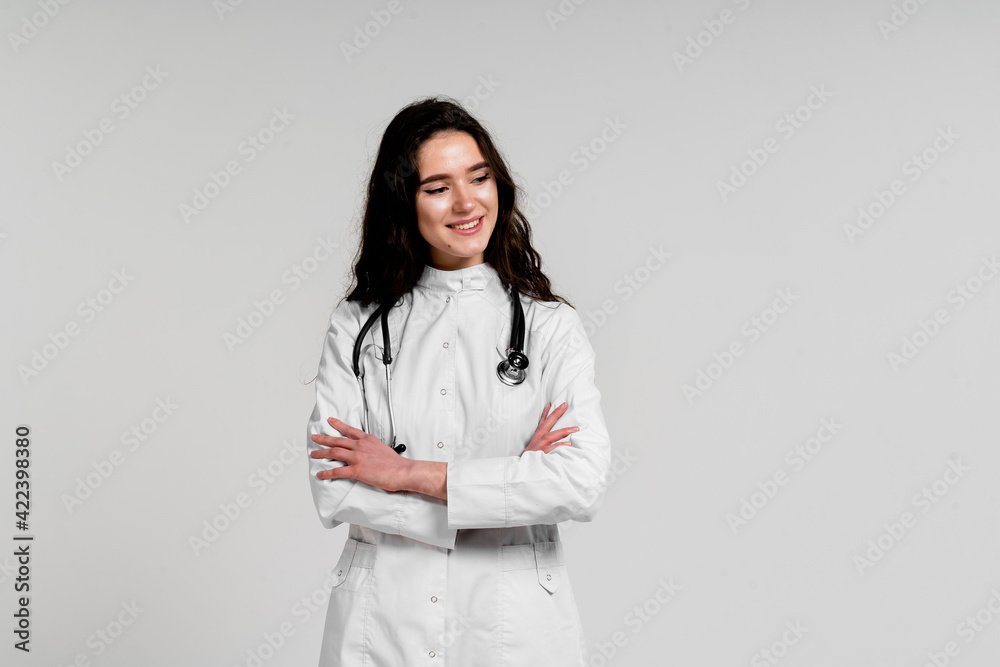 Girl surgeon in medical dress with curly hair on white background. 3rd wave of coronavirus covid-19 epidemy. Girl surgeon in medical dress with curly hair on white background. 3rd wave of coronavirus covid-19 epidemy.