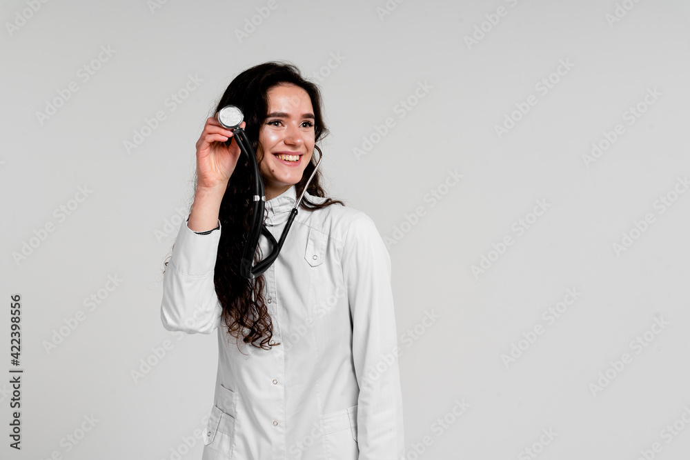 Doctor in medical robe with stethoscope at coronavirus covid-19 period. Nurse in white medical dress on white background