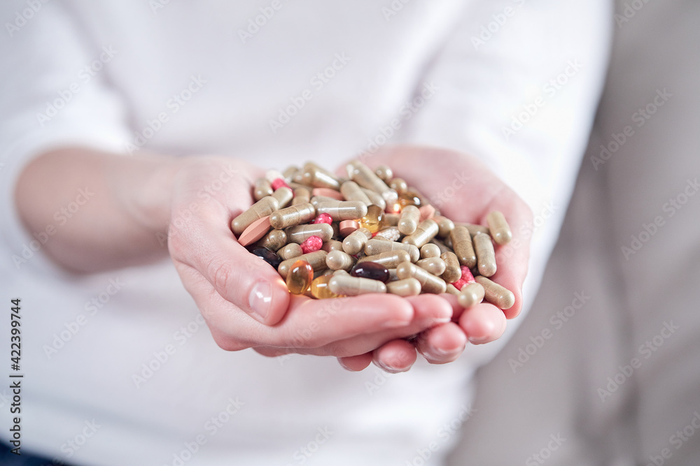 Hand of young man with pills, closeup Hand of young man with pills, closeup