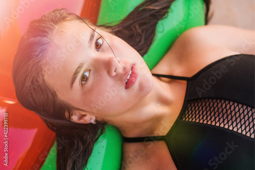 Happy teenage girl floating with watermelon lilos, sea - having fun swimming in summer vacation - Youth lifestyle, travel and party concept