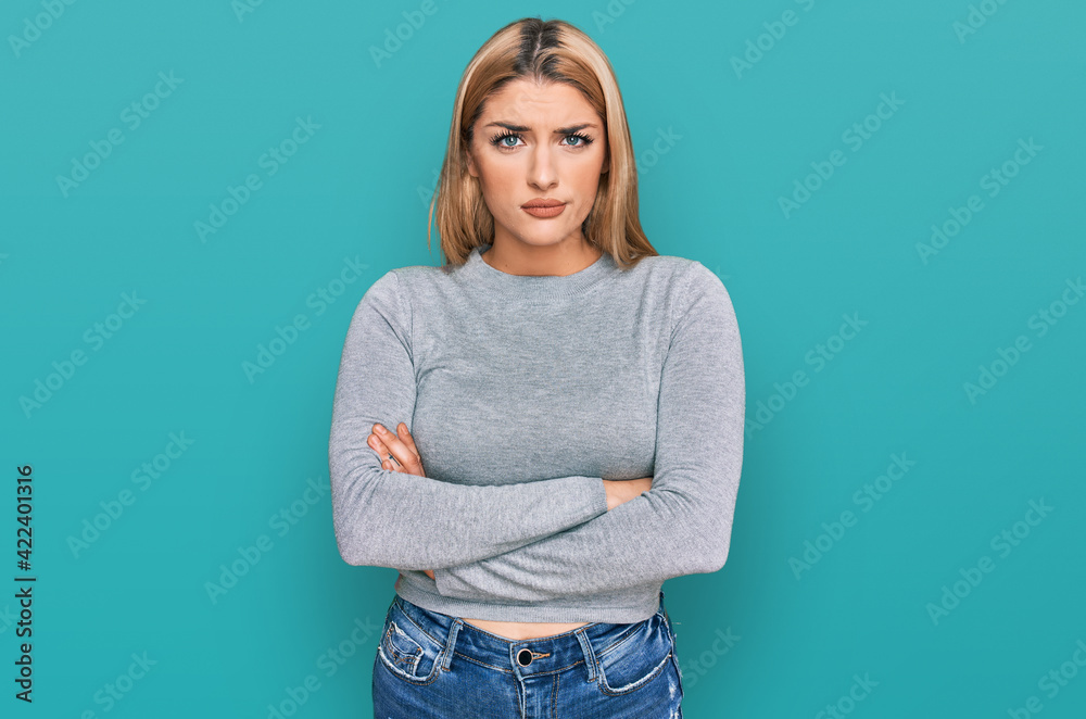 Young caucasian woman wearing casual clothes skeptic and nervous, disapproving expression on face with crossed arms. negative person. Young caucasian woman wearing casual clothes skeptic and nervous, disapproving expression on face with crossed arms. negative person.